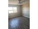 Bright bedroom with gray laminate flooring and ceiling fan at 4745 E Flamingo Rd, Las Vegas, NV 89121