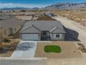 New single-story house with gray tile roof and small front yard at 5130 Valero Ct, Pahrump, NV 89060