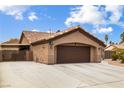 One-story home with brown garage door and gated driveway at 5445 Rose Hills St, Las Vegas, NV 89149