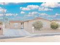 Single-story house with a landscaped yard and driveway at 6215 Newville Ave, Las Vegas, NV 89103