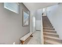 Entryway with staircase and bench, featuring tiled floors at 6276 Point Isabel Way, Las Vegas, NV 89122