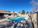 Community swimming pool with surrounding patio at 7200 Pirates Cove Rd # 2005, Las Vegas, NV 89145