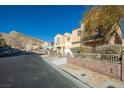 Street view of houses with mountain backdrop at 10516 Blanca Peak Ave, Las Vegas, NV 89129