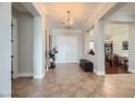 Bright and spacious entryway with tile flooring and views to dining area at 1779 Sebring Hills Dr, Henderson, NV 89052