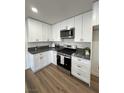 Updated kitchen with white shaker cabinets and sleek countertops at 2413 Valparaiso St, Las Vegas, NV 89108