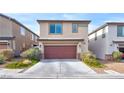 Two-story home featuring a two-car garage, neutral colored stucco, and stone accents at 2694 Marvel Astoria St, Henderson, NV 89044