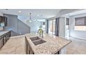 Kitchen island with double sinks and granite countertops at 2694 Marvel Astoria St, Henderson, NV 89044