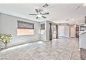 Expansive living room with tile flooring, neutral walls, and abundant natural light from large windows at 2694 Marvel Astoria St, Henderson, NV 89044