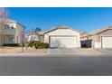 Two-story house with a two-car garage and well-maintained lawn at 4820 Morning Splash Ave, Las Vegas, NV 89131