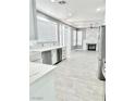 Open concept kitchen and living area with a modern fireplace at 9701 Ann Arbor Ln, Las Vegas, NV 89134