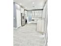 Modern kitchen features stainless steel appliances and gray tile flooring at 9701 Ann Arbor Ln, Las Vegas, NV 89134