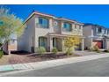 Two-story house with a two-car garage and desert landscaping at 10306 Coastline Creek Ct, Las Vegas, NV 89141