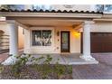 Front porch with columns, entry door, and window at 11017 Ladyburn Ct, Las Vegas, NV 89141