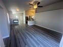 Open living area with wood-look floors, fireplace, and kitchen view at 124 Winley Chase Ave, North Las Vegas, NV 89032