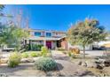 Two-story house with red door, landscaping, and brick accents at 1510 Marita Dr, Boulder City, NV 89005