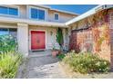 Front entry with red door, brick wall, and walkway at 1510 Marita Dr, Boulder City, NV 89005