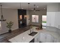 Open concept kitchen with island, white cabinets and quartz countertops at 1908 Quail Point Ct, Las Vegas, NV 89117