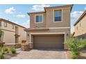 Tan two-story house with a two-car garage and nicely landscaped front yard at 1937 Shanon Michelle Ave, North Las Vegas, NV 89031