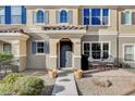 Small front patio with seating area, adjacent to a townhome at 2077 Via Firenze, Henderson, NV 89044