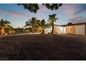 Night view of house exterior showcasing the landscaping and a gravel driveway at 274 Doobie Ave, Las Vegas, NV 89183