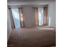 Spacious living room with neutral carpet and sliding glass doors at 4031 Gold Coast Dr, Las Vegas, NV 89121