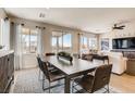 Open concept dining area adjacent to living room, featuring large windows at 4420 E Brusca Way, Pahrump, NV 89061