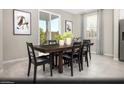 Dining area with a dark wood table and black chairs at 5192 Hisopo St # Lot 22, Las Vegas, NV 89122