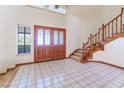 Bright entryway with tile floors, double doors, and a staircase at 56 Sawgrass Ct, Las Vegas, NV 89113