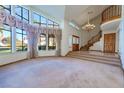 Spacious living room with large windows and vaulted ceiling at 56 Sawgrass Ct, Las Vegas, NV 89113