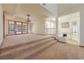 Open-concept living area featuring a fireplace and large windows, ideal for entertaining guests at 56 Sawgrass Ct, Las Vegas, NV 89113