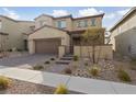 Two-story house with a brown garage door and landscaped front yard at 595 Beverly Pine Pl, Henderson, NV 89011