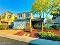 Two-story house with a two-car garage and landscaped yard at 6234 Hopeful Light Ave, Las Vegas, NV 89139