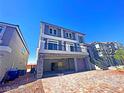 Two-story house with a two-car garage, stone exterior, and balcony at 6335 Rock Stream Ln, Las Vegas, NV 89141