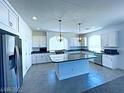 Modern kitchen with an island, stainless steel appliances, and white cabinets at 6335 Rock Stream Ln, Las Vegas, NV 89141