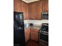 Kitchen featuring granite countertops, stainless steel appliances, and wooden cabinets at 658 Forest Peak St, Henderson, NV 89011