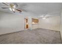 Spacious living room with neutral carpeting and ceiling fans at 6750 Del Rey Ave # 262, Las Vegas, NV 89146