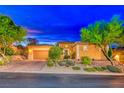 Beautiful desert landscaping surrounds this single-story home with a 2 car garage at 70 Portezza Dr, Henderson, NV 89011