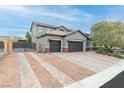 Two-story house with three car garage and gated driveway at 7306 Puckershire St, Las Vegas, NV 89166