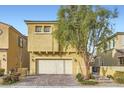 Charming two-story home featuring a two-car garage, desert landscaping, and a brick-paved driveway at 8031 Tank Loop St, Las Vegas, NV 89166