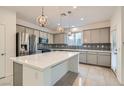 Modern kitchen with gray cabinets, stainless steel appliances, and an island at 8031 Tank Loop St, Las Vegas, NV 89166