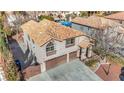 Two-story house with solar panels and a three-car garage at 8220 Fawn Heather Ct, Las Vegas, NV 89149