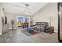 Spacious living room featuring a gray sectional sofa and large windows at 9520 Yucca Blossom Dr, Las Vegas, NV 89134