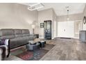 Open living room with gray sectional sofa and wood-look flooring at 9520 Yucca Blossom Dr, Las Vegas, NV 89134