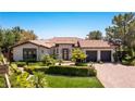 Single story home with Spanish tile roof, landscaping and two-car garage at 1 Panorama Crest Ave, Las Vegas, NV 89135