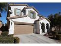 Two-story house with a tan garage door and landscaping at 10418 Prairie Mountain Ave, Las Vegas, NV 89166