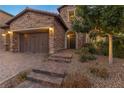 Brick home with a three-car garage and walkway leading to the entrance at 11952 Girasole Ave, Las Vegas, NV 89138