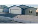 Modern home with gray and white exterior, two-car garage, and small front yard at 1308 E Nelson Ave, North Las Vegas, NV 89030