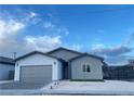 New home with gray and white exterior, two-car garage, and modern design at 1308 E Nelson Ave, North Las Vegas, NV 89030