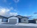 New construction home featuring gray and white exterior and a two-car garage at 1308 E Nelson Ave, North Las Vegas, NV 89030