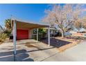 Carport with red door and mature tree landscaping at 2828 Richfield Blvd, Las Vegas, NV 89102